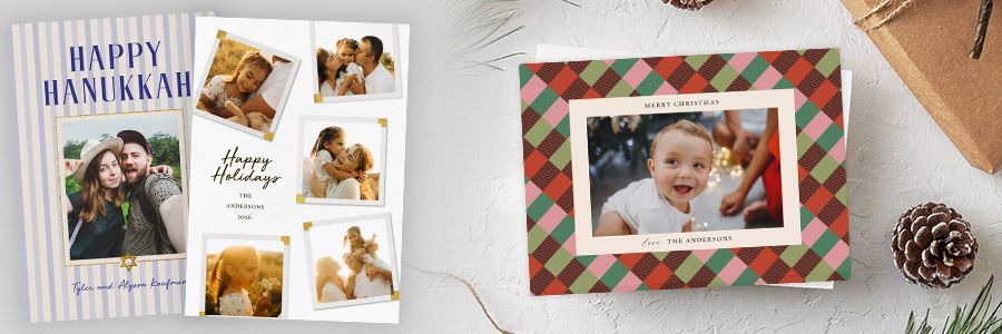 A variety of holiday and Christmas Cards on a table.