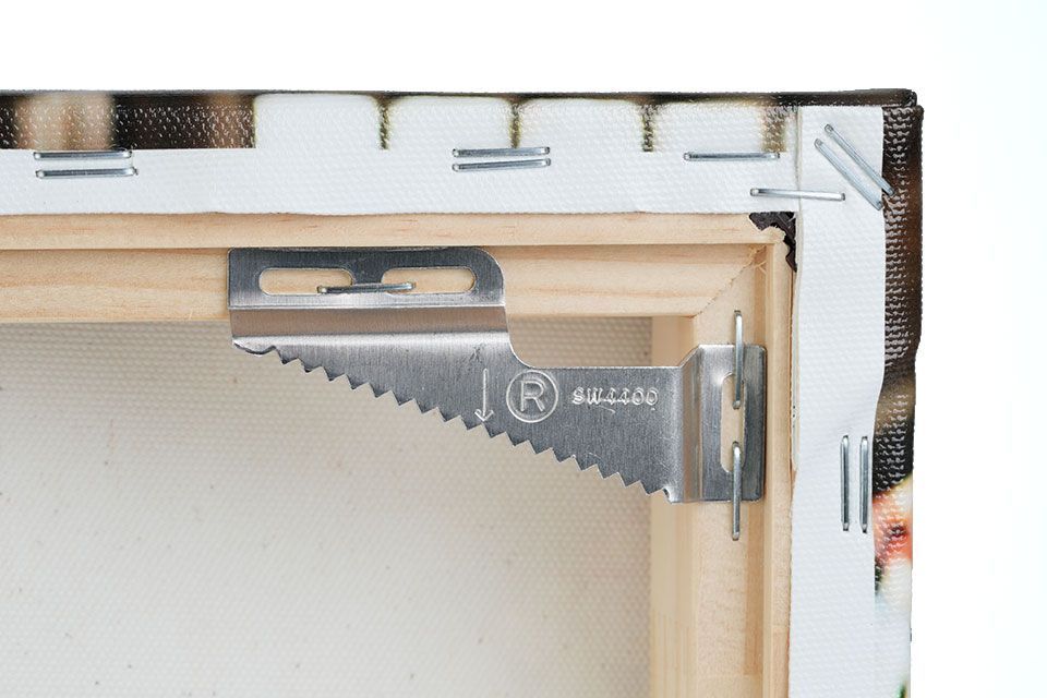 Wall buddies hanger secured to the back corner of the stretched canvas