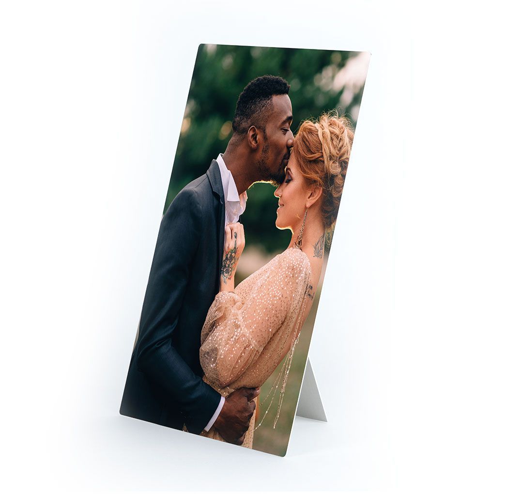 A metal print of a new wedding couple holding each other