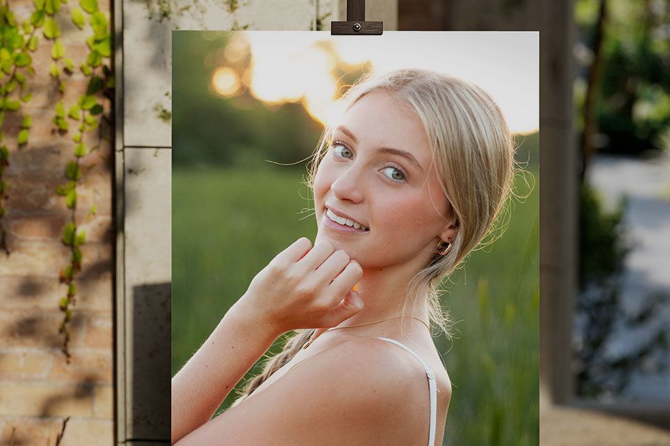 A poster of a young woman graduate