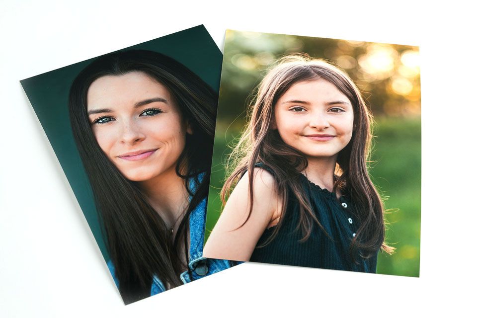 2 portraits of young women on a table