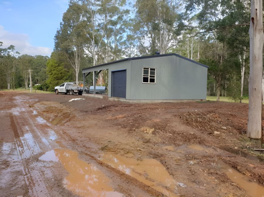 A Shed is Sitting on the Side of a Dirt Road — Hastings Valley Sheds in Port Macquarie, NSW