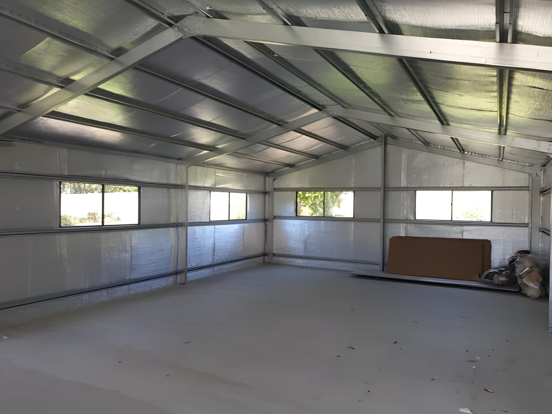 A Large Empty Shed With a Lot of Windows and a Roof — Hastings Valley Sheds in Wauchope, NSW
