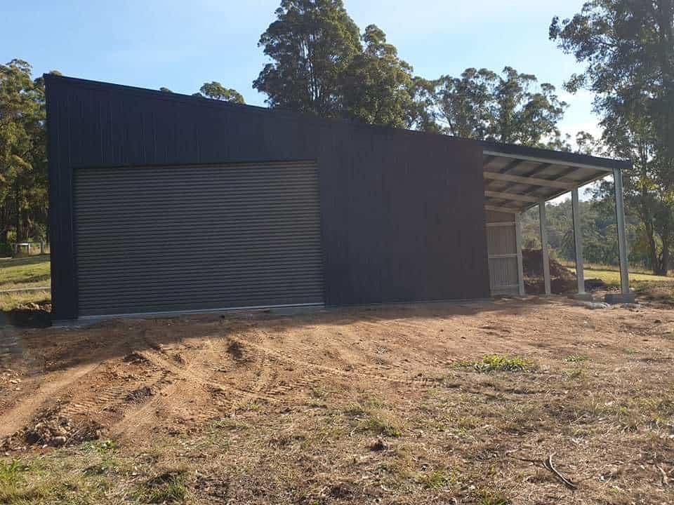 A Black Shed With a Covered Porch — Hastings Valley Sheds in Wauchope, NSW