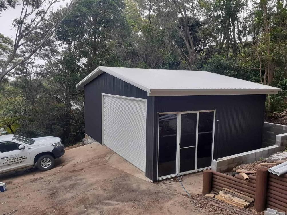 A White Truck is Parked in Front of a Black Garage — Hastings Valley Sheds in Wauchope, NSW