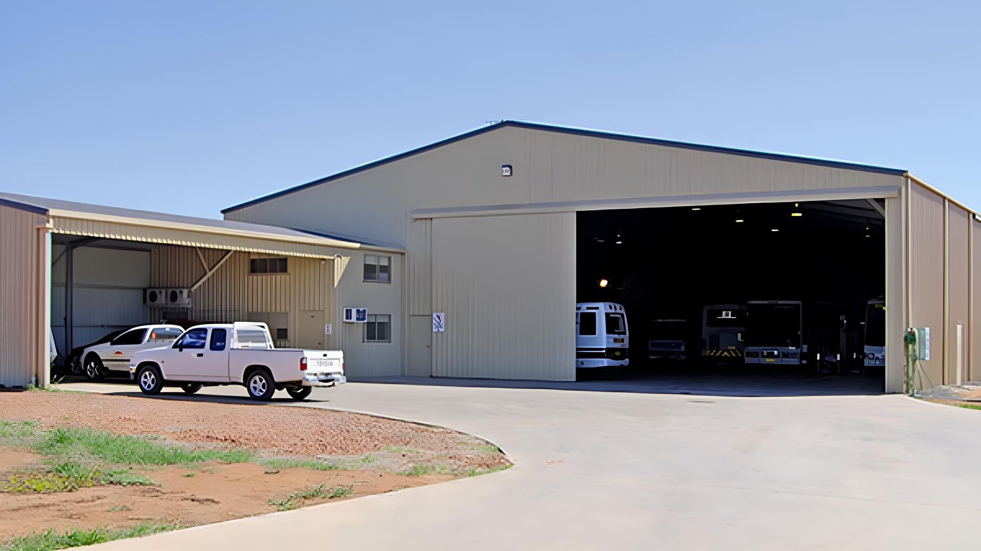 A White Truck is Parked in Front of a Large Building — Hastings Valley Sheds in Wauchope, NSW