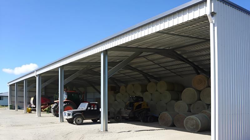 A Shed Filled With Hay Bales and Tractors — Hastings Valley Sheds in Wauchope, NSW