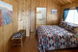 A bedroom with a bed and a painting on the wall.
