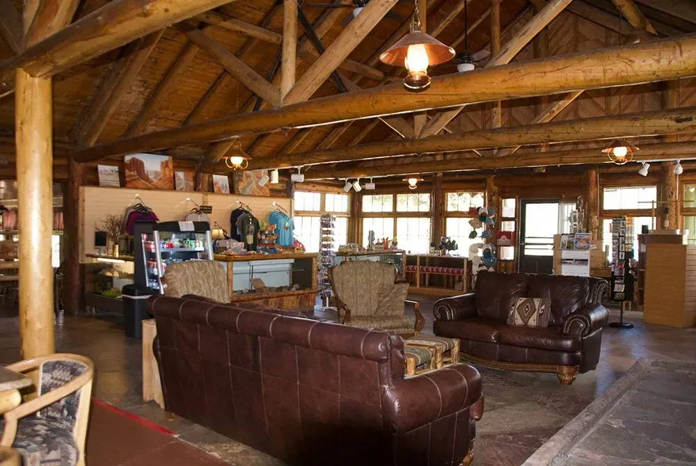 A living room with a lot of furniture and a wooden ceiling