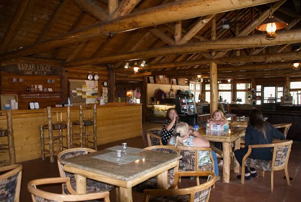 A group of people are sitting at tables in a restaurant.
