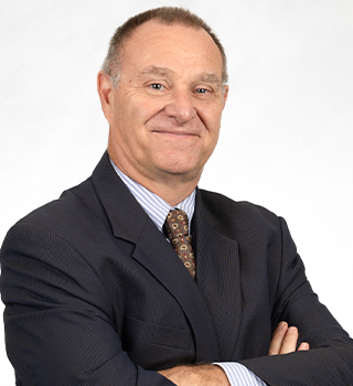 A man in a suit and tie with his arms crossed
