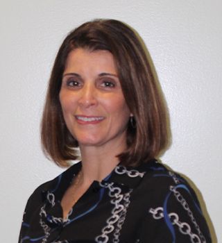 A woman wearing a black shirt with chains on it