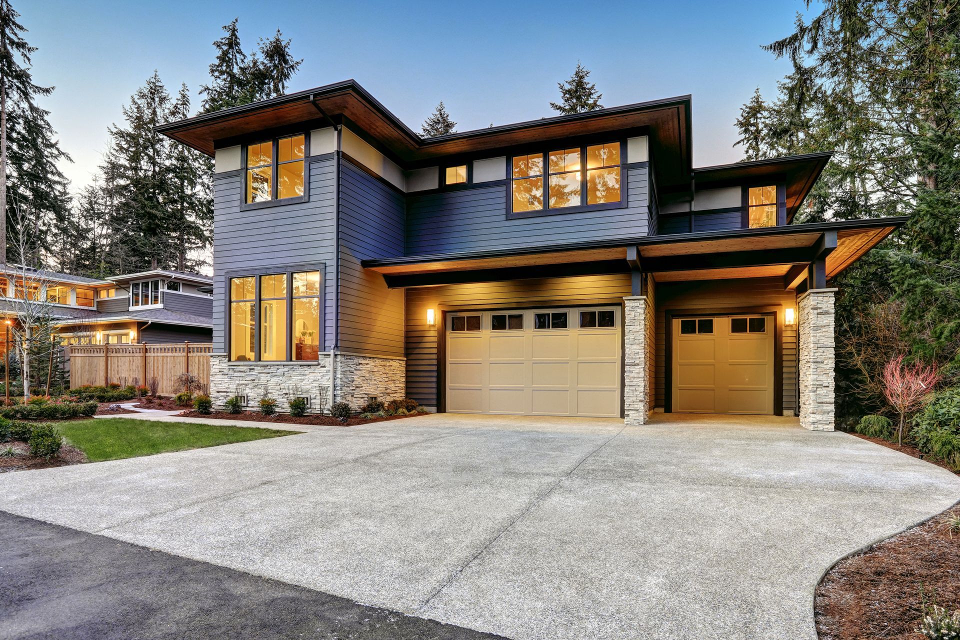 A Large House With a Garage and a Driveway in Front of It
