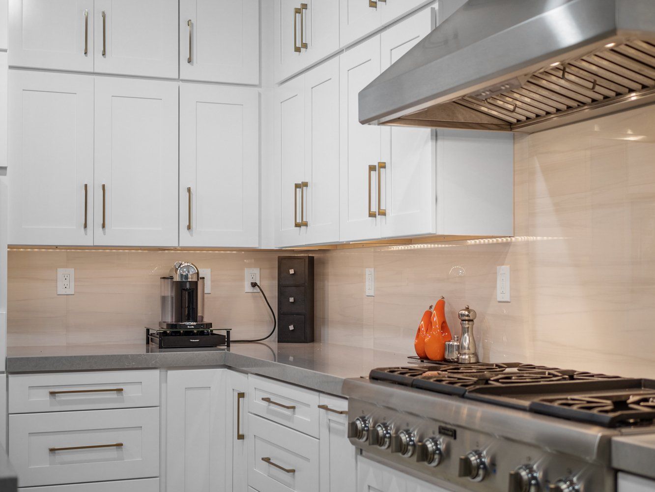 Natural beige, sand color backsplash with white shaker cabinets in kitchen remodel in Aliso Viejo, CA