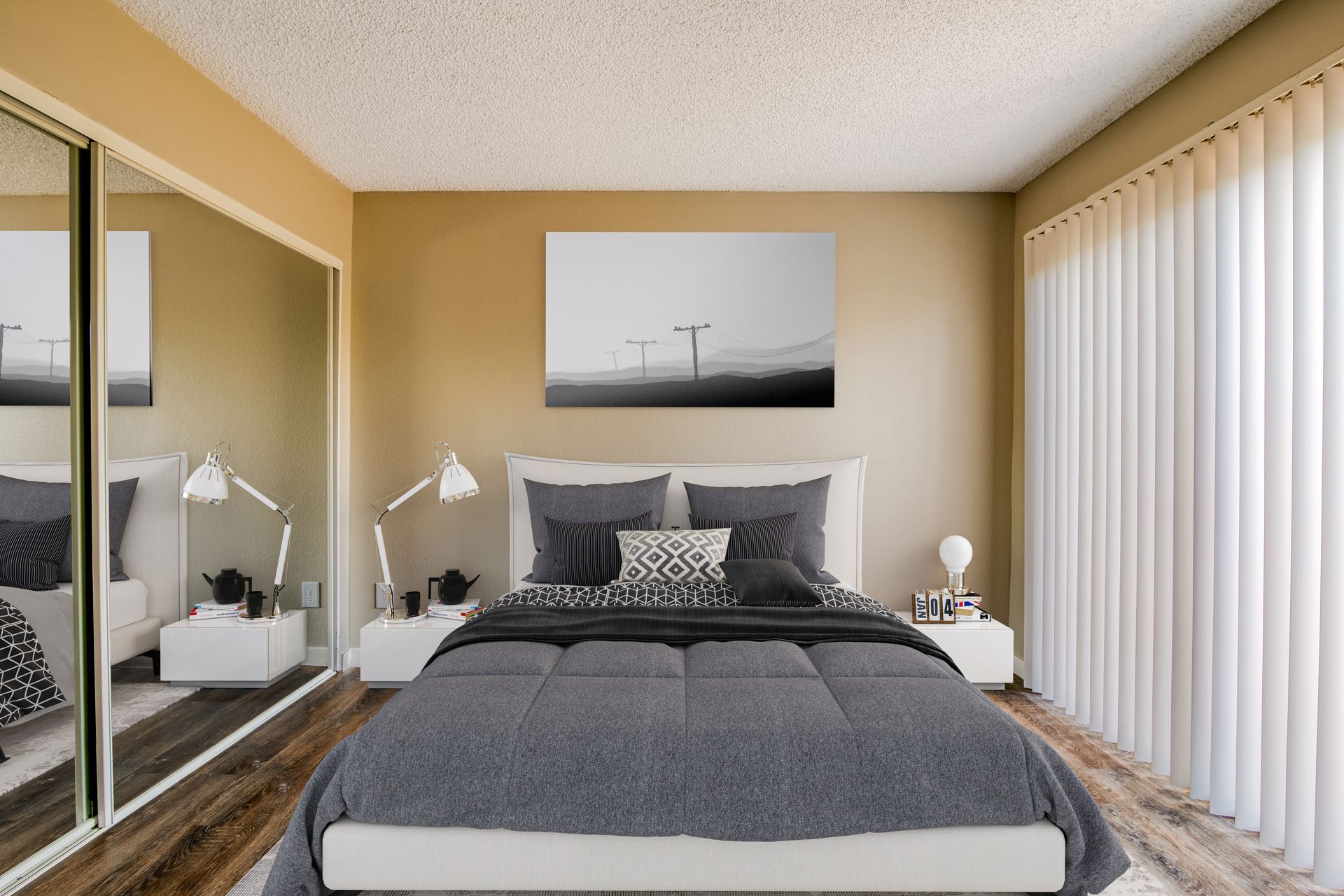 A bedroom with a large bed , sliding glass doors , nightstands , and a painting on the wall.