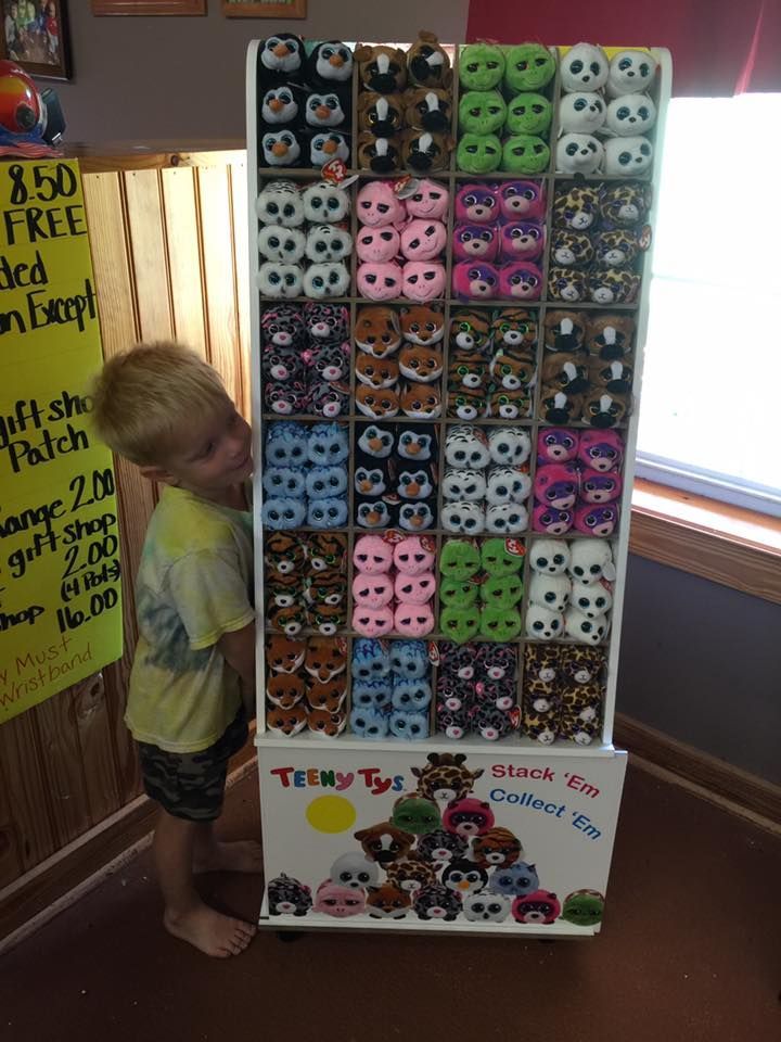 Boy looking at a display of plush Teeny Ty stuffed animals in a store.