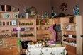 Shop interior with wooden shelves displaying various items, including vases and decorative objects.