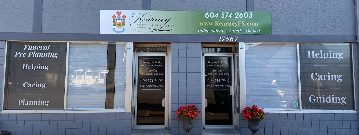 The storefront of Florence Funeral Home with a green sign, glass doors, and window decals listing services.