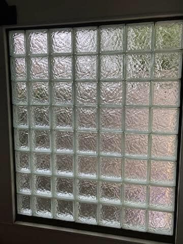 A square window made of textured glass blocks arranged in a grid pattern.