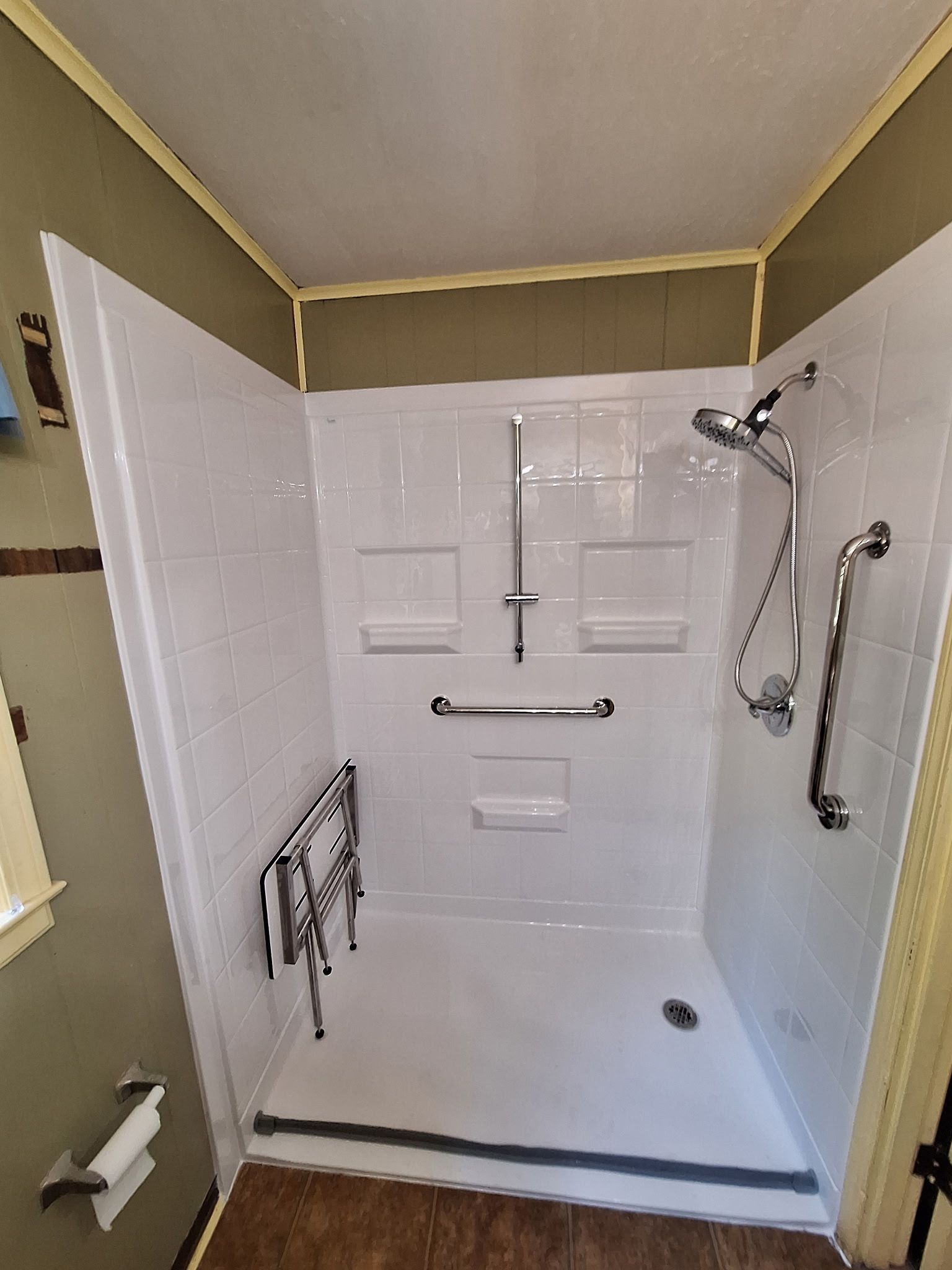 Top-down view of a white bathtub with bath accessories, towels, and woven baskets in a bathroom