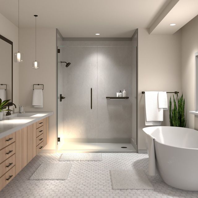 Modern bathroom with glass shower, freestanding tub, vanity, and light tile flooring