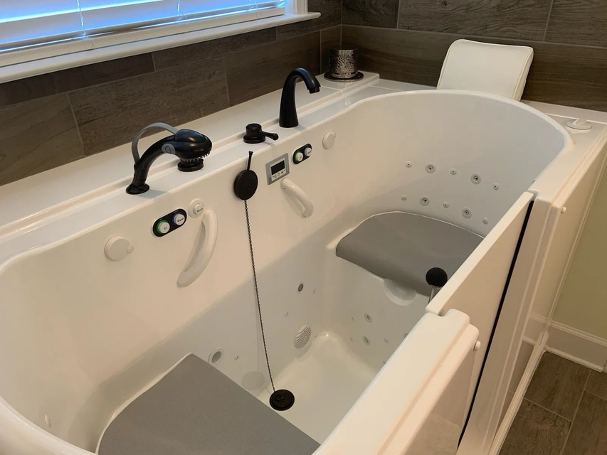 Walk-in bathtub with grab bars and built-in seat in a bathroom