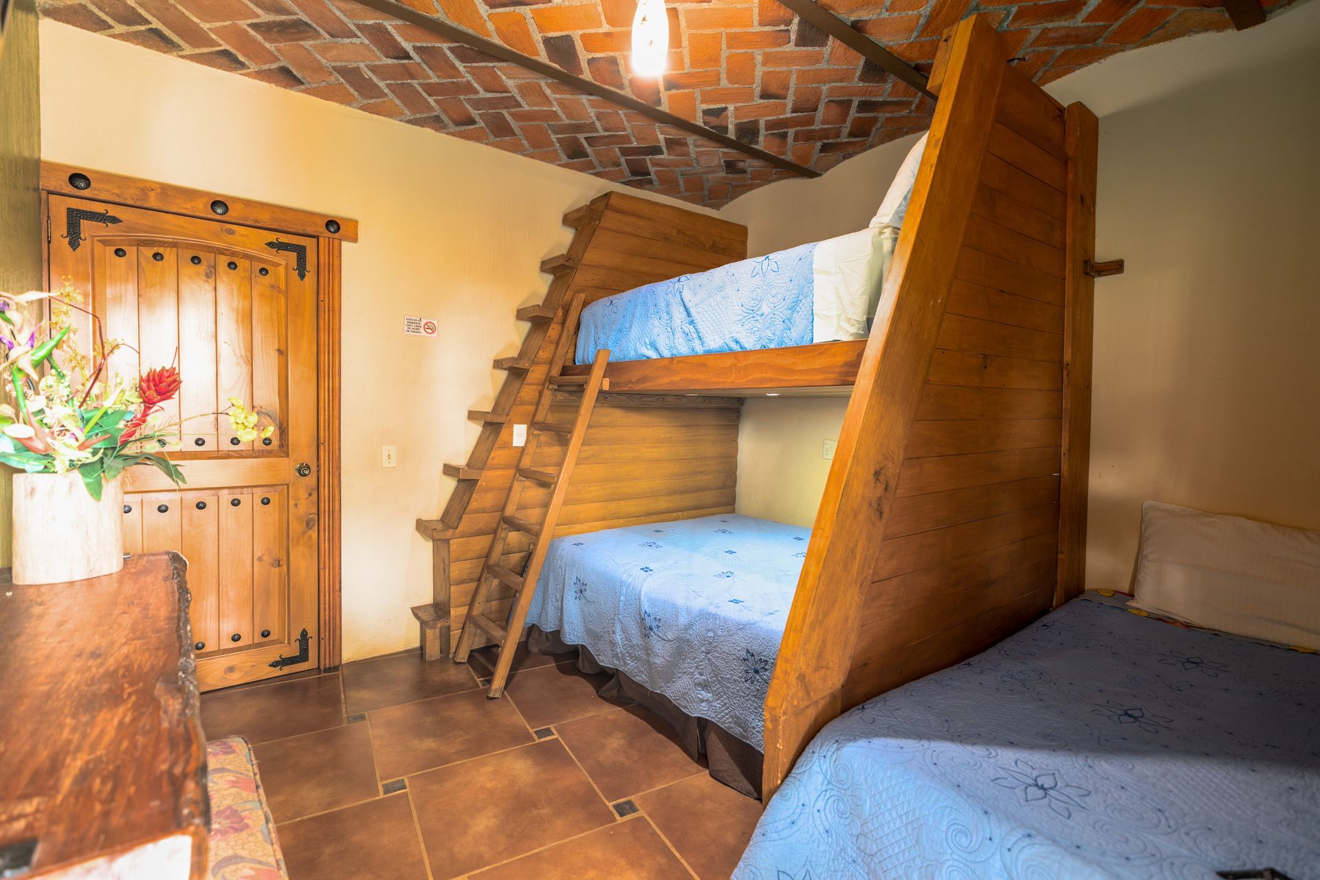 A bedroom with two bunk beds and a staircase.