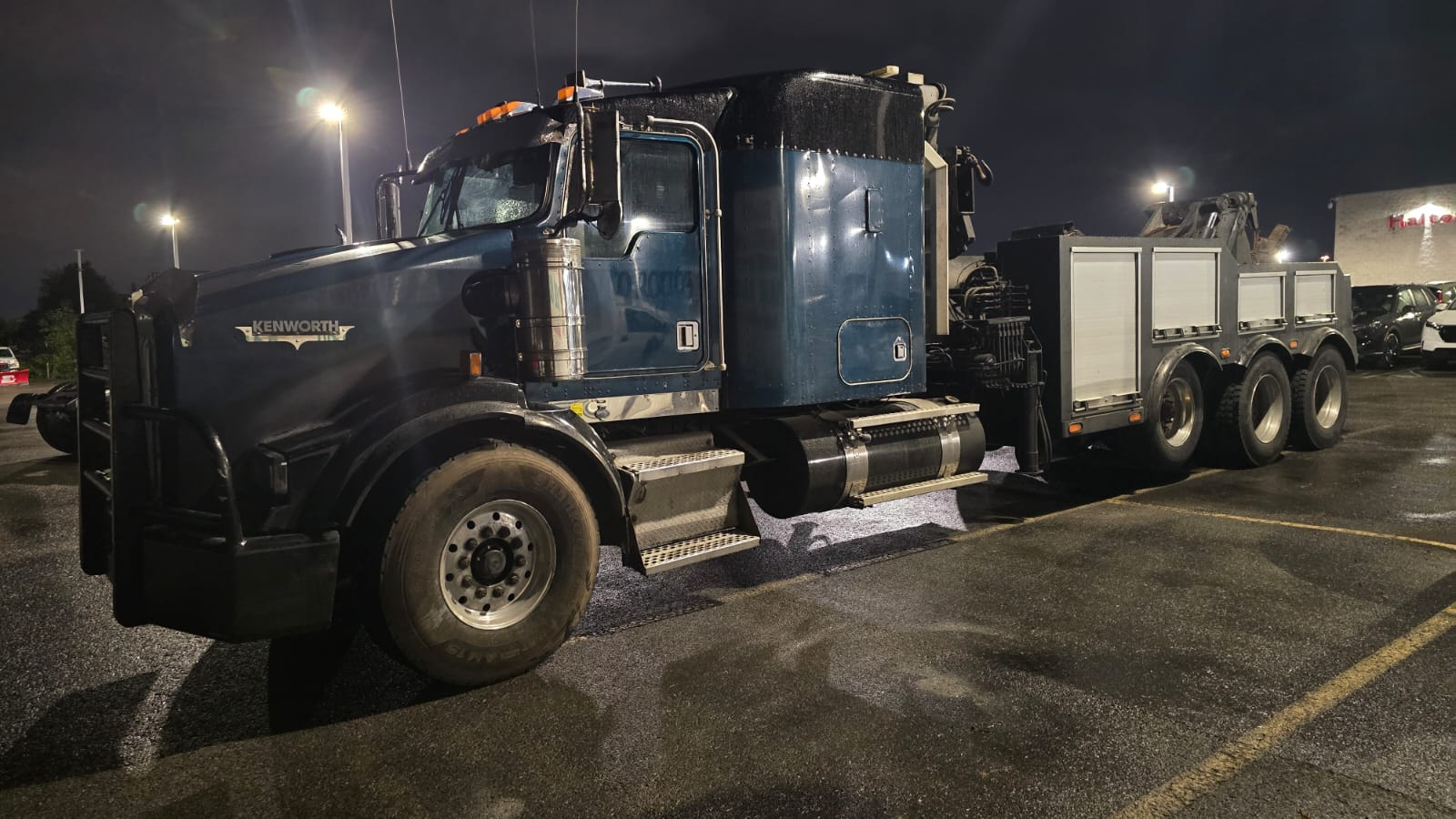 Our heavy-duty tow truck in a parking lot at night