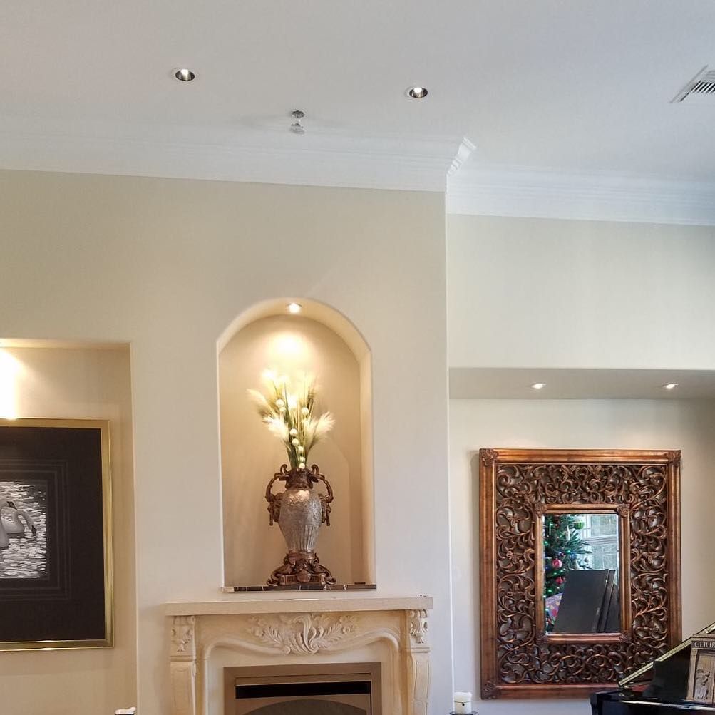 A living room with a fireplace and a mirror