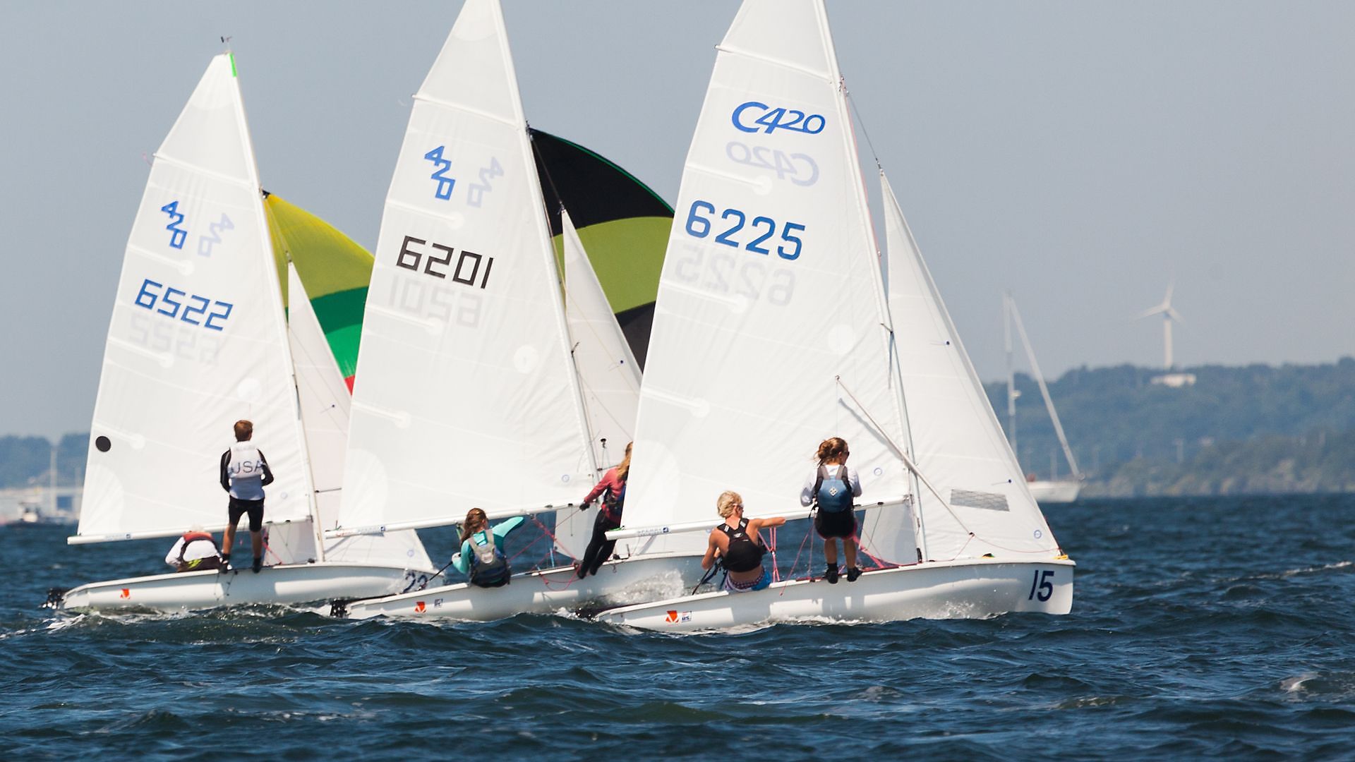 A group of sailboats with the number 6226 on the sails