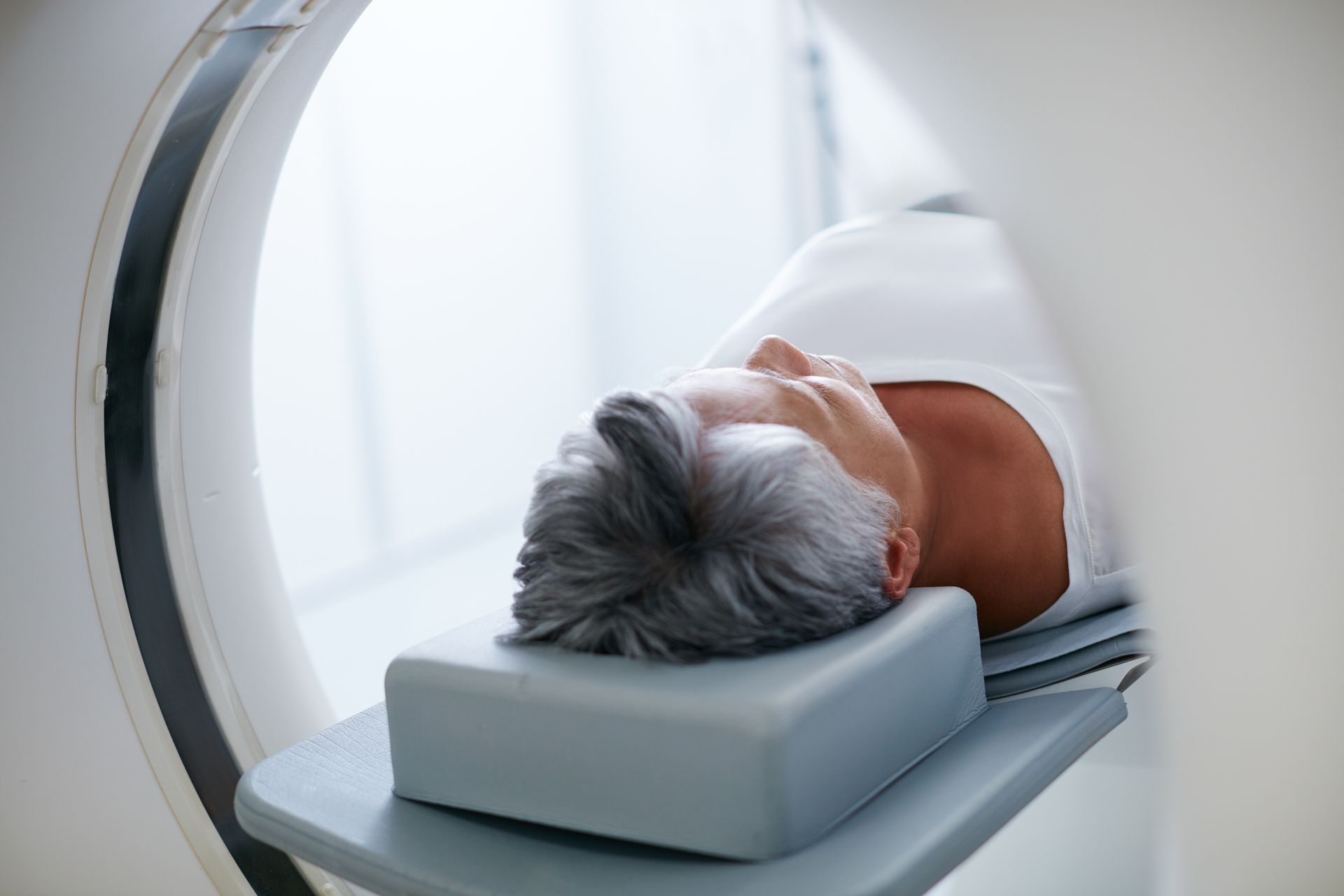 A woman is getting a ct scan of her head. A woman is getting a ct scan of her head.