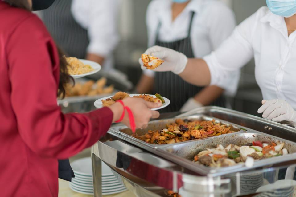 woman serving food to a visitor