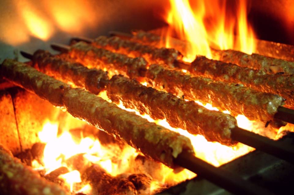 view of meat on skewers on grill