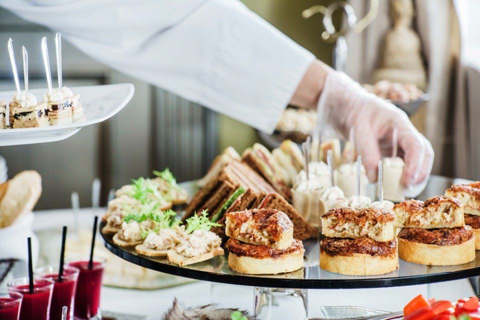 man arranging food on plate