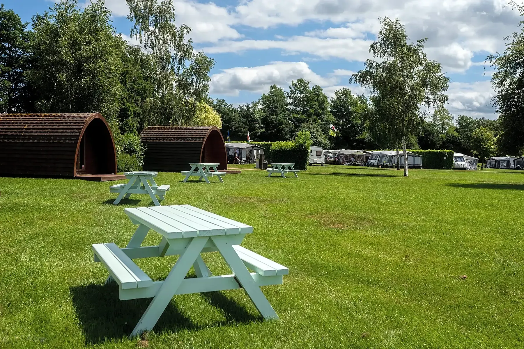 Spacious family-friendly camping and glamping site at Applewood Countryside Park in Norfolk, featuring glamping pods and caravans