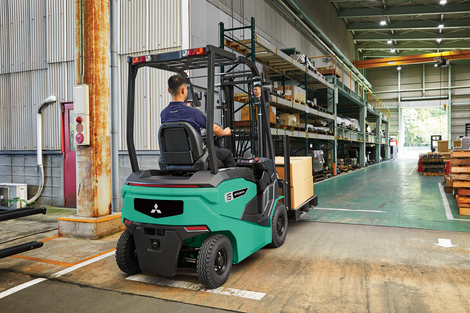A woman is sitting in a forklift in a warehouse.