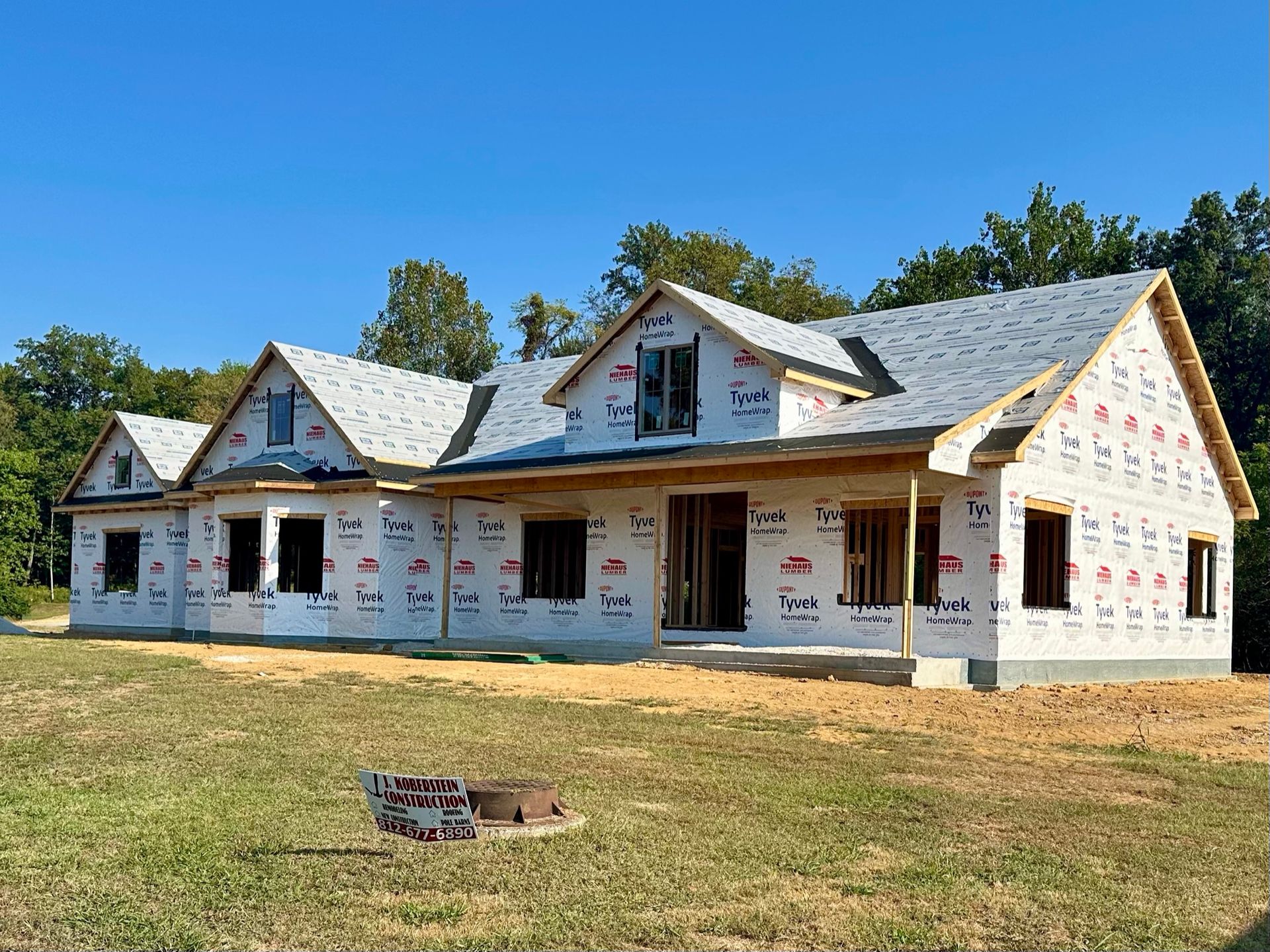 A Large White House With A Wooden Deck In The Backyard - Princeton, IN - J. Koberstein Construction