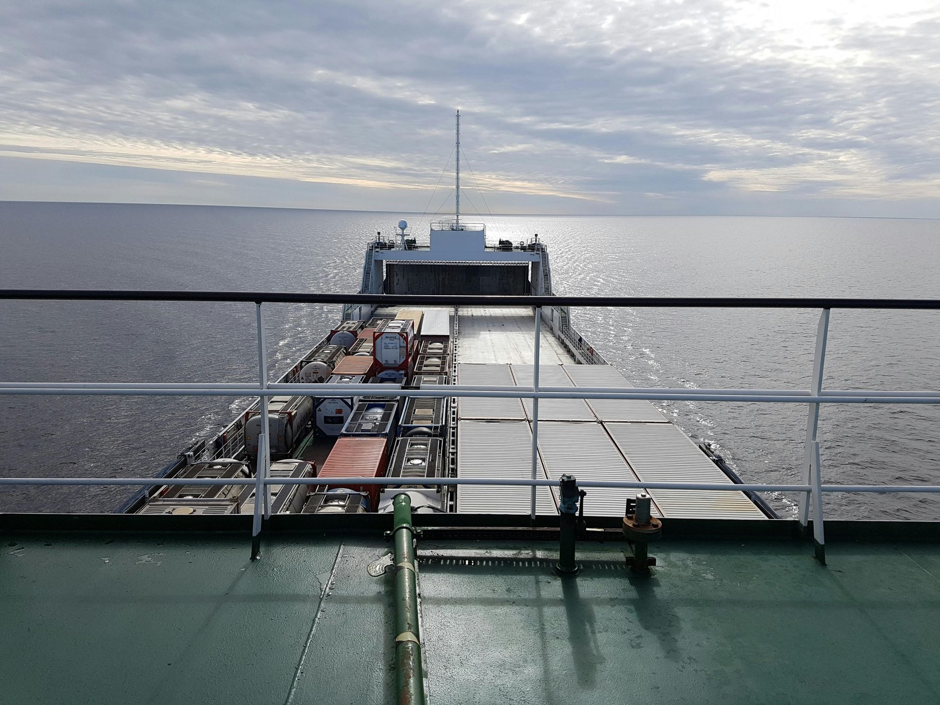A view of a large body of water from the deck of a ship