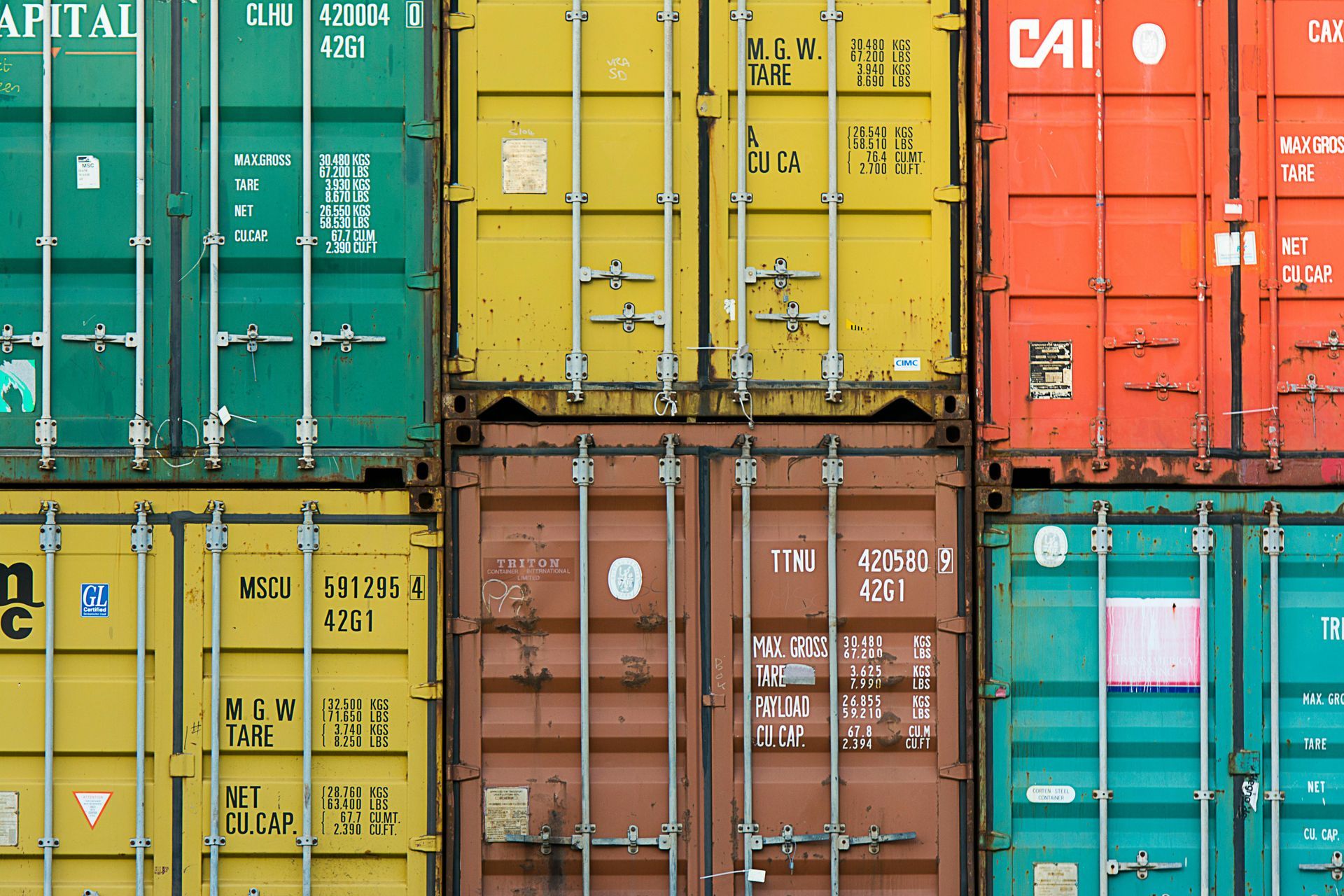 A bunch of shipping containers are stacked on top of each other.