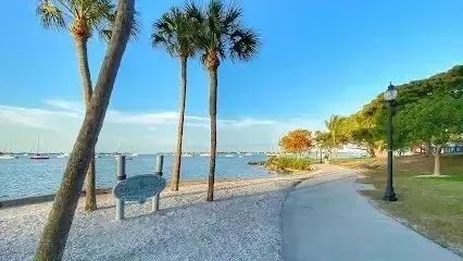 Hvac-Contractor-Bradenton-A path leading to a beach with palm trees and a sign.