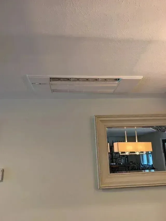 Hvac Contractor Bradenton - A living room with a mirror and a ceiling fan.