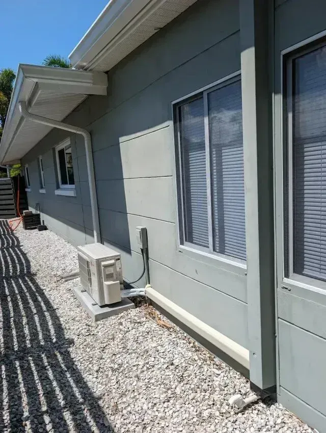 Hvac Contractor Bradenton - A house with a lot of windows and a drain on the side of it