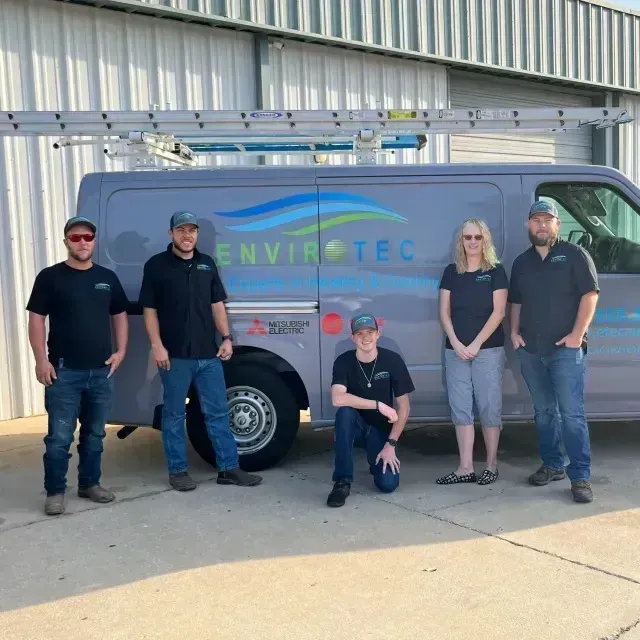Hvac-Contractor-Bradenton-A group of people standing in front of a van that says envirotec