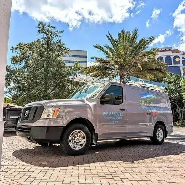 Hvac Contractor Bradenton - A gray van is parked on a brick driveway with palm trees in the background