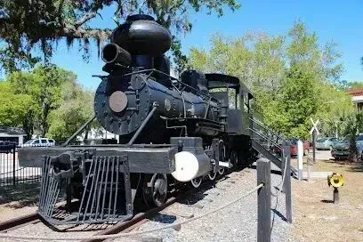 Hvac-Contractor-Bradenton-A black train is parked on the tracks in a park.