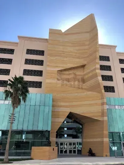 Hvac-Contractor-Bradenton-A large building with a palm tree in front of it
