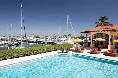 Hvac-Contractor-Bradenton-A large swimming pool in front of a house with boats in the background.