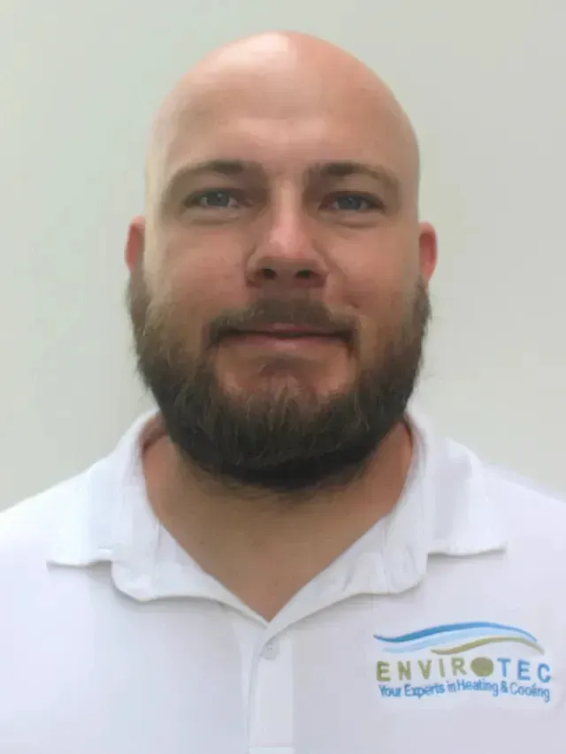 Hvac-Contractor-Bradenton-Bald man with a beard in a white polo shirt; Envirotec logo visible.