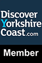 The logo for discover yorkshire coast.com is on a blue background.