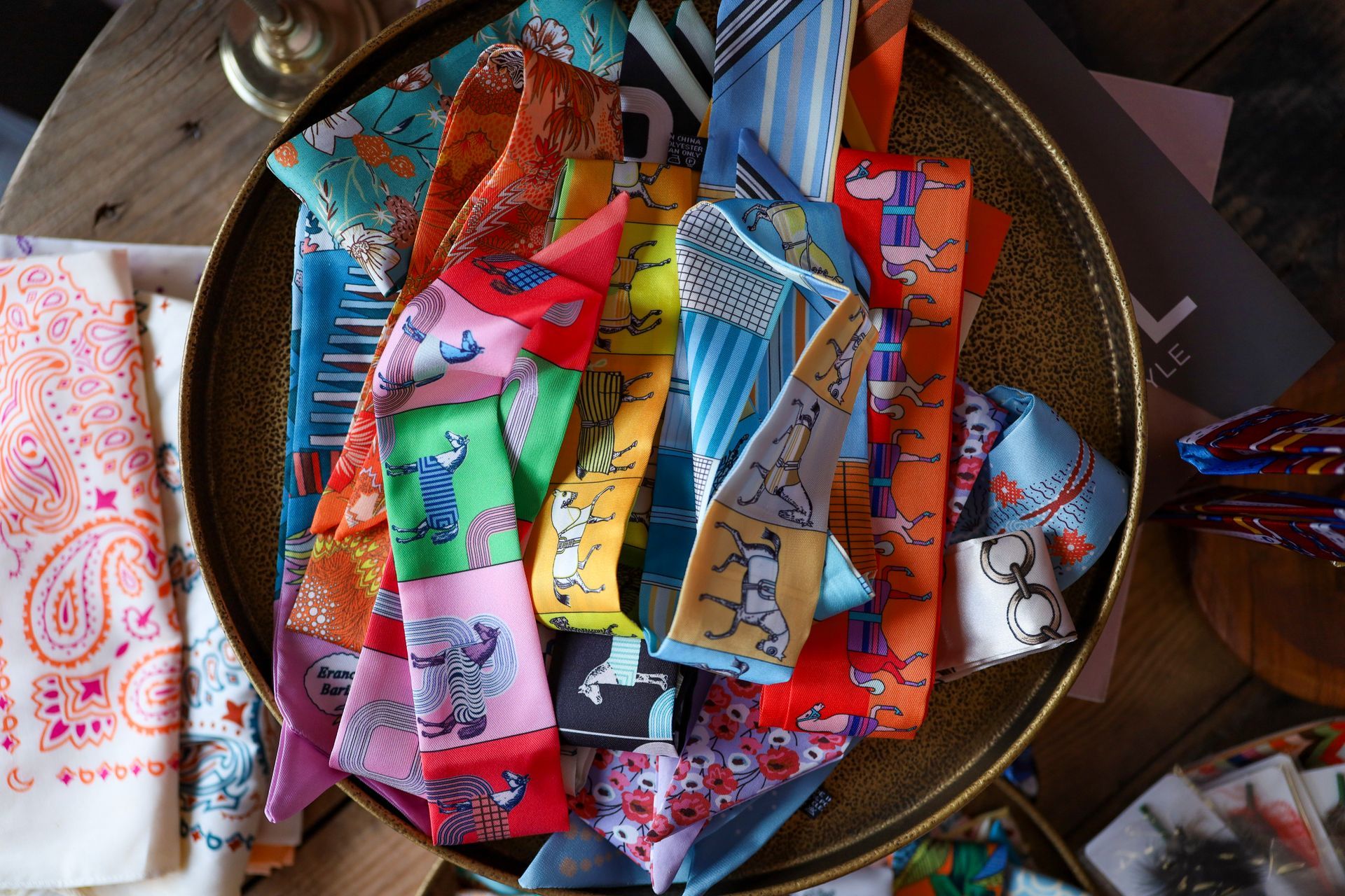 Colorful fabric scraps and patterned cloth strips piled in a round woven basket